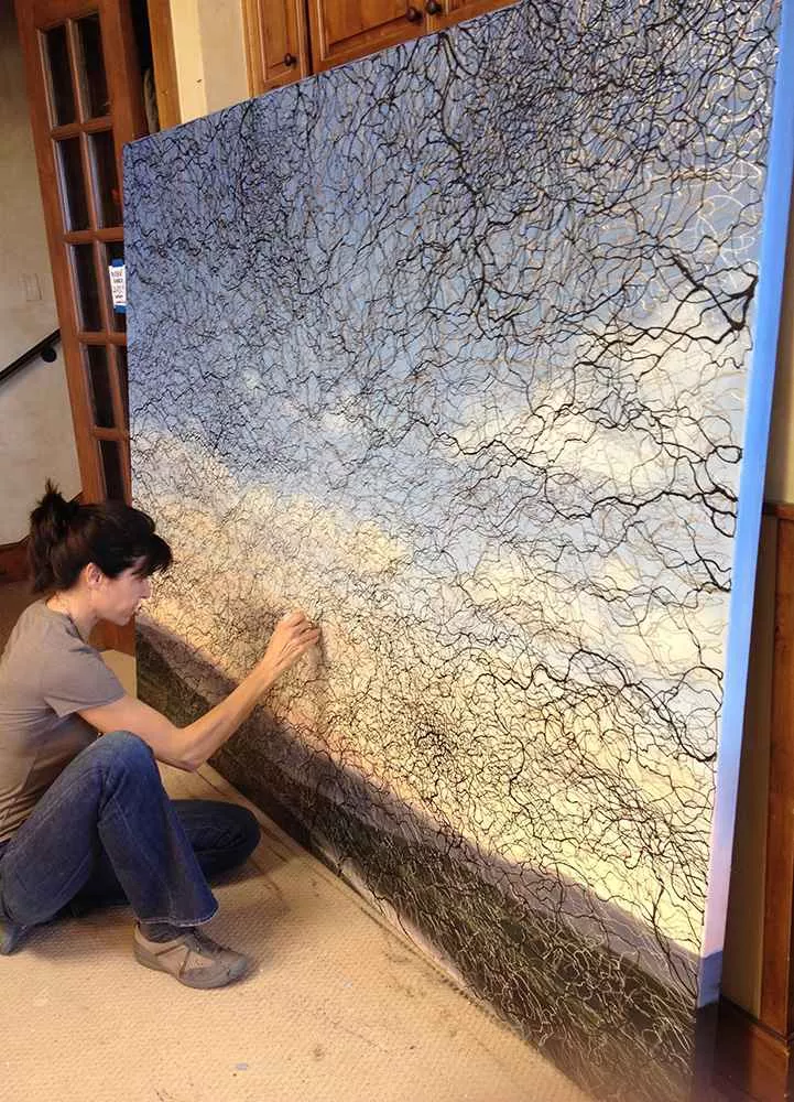 Tania Dibbs painting an overlay in her studio