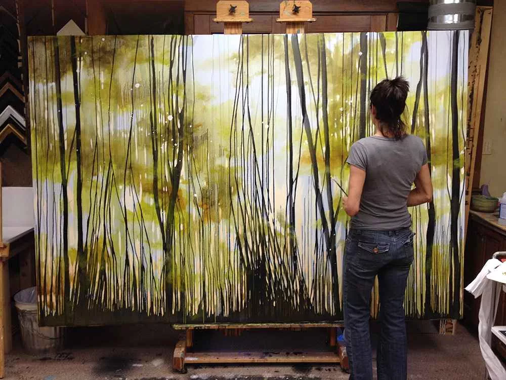 Tania Dibbs painting the piece Defaulted in her studio