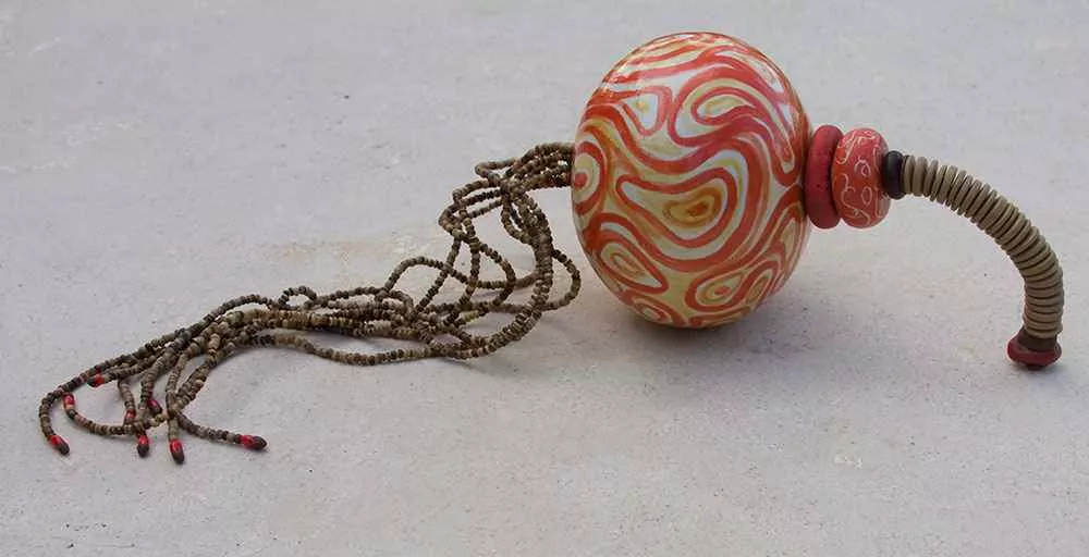 Red Vector, 22″ long, 5″ sphere, mixed media by Tania Dibbs