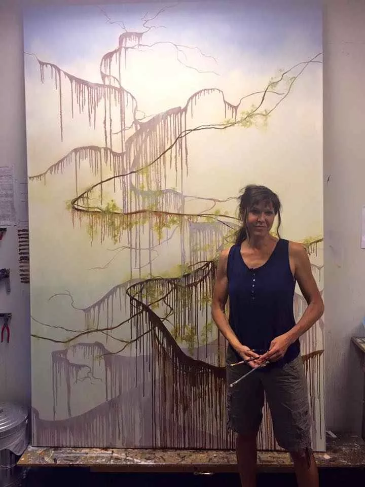 Tania Dibbs working on a painting in her studio